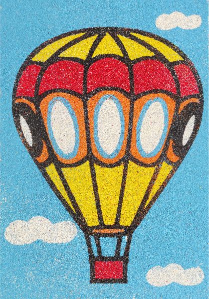 Colorful hot air balloon sand painting with blue sky and clouds.